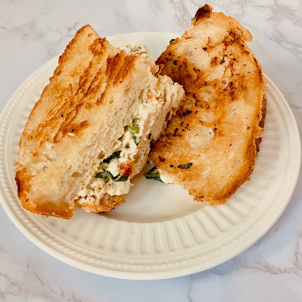 grilled cheese layered on a white plate