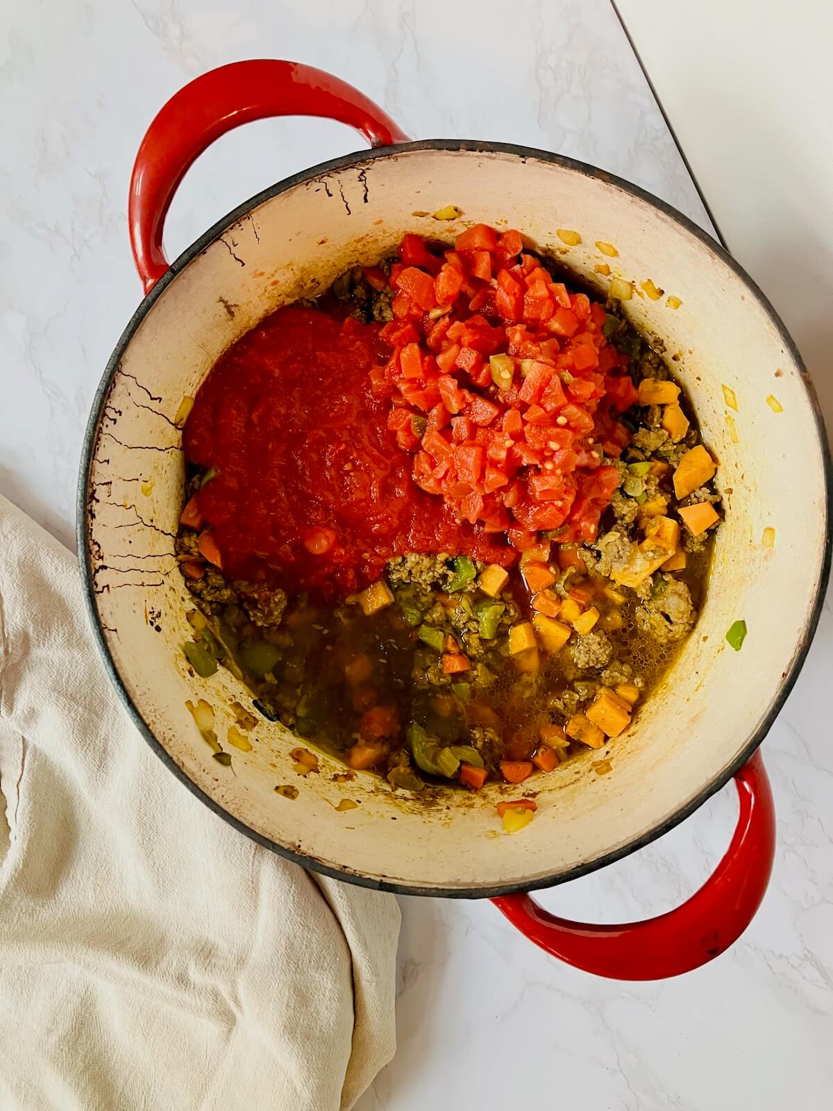 pot of chickpea chili with tomatoes on top