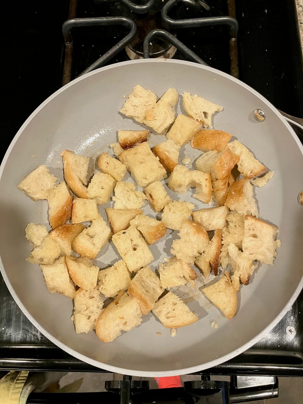ivory pan with small cut up bread for croutons