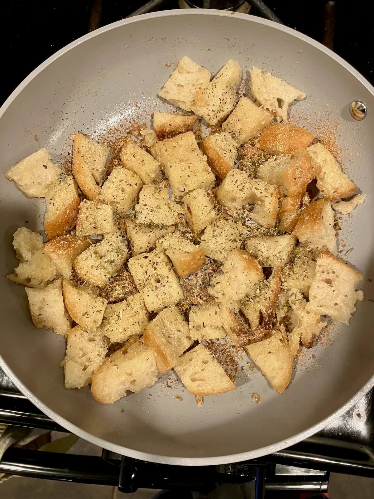ivory pan with small cut up bread covered in seasoning