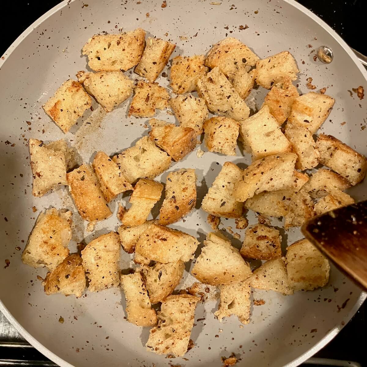 ivory pan with toasted croutons covered in seasoning