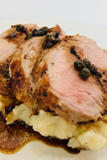 roasted pork tenderloin on top of mashed potatoes