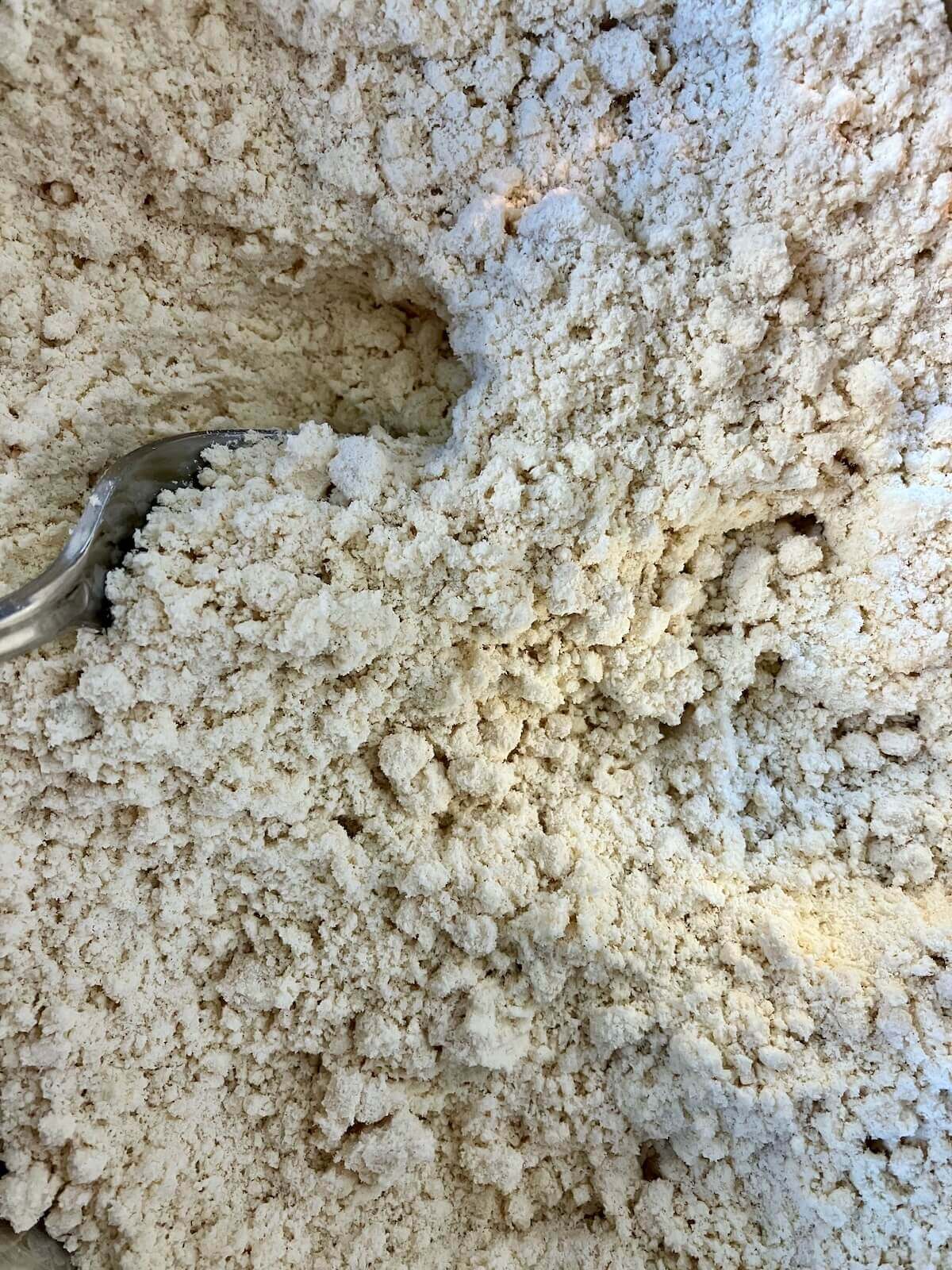 butter cut into dry ingredients for chicken and dumplings. it looks like sand