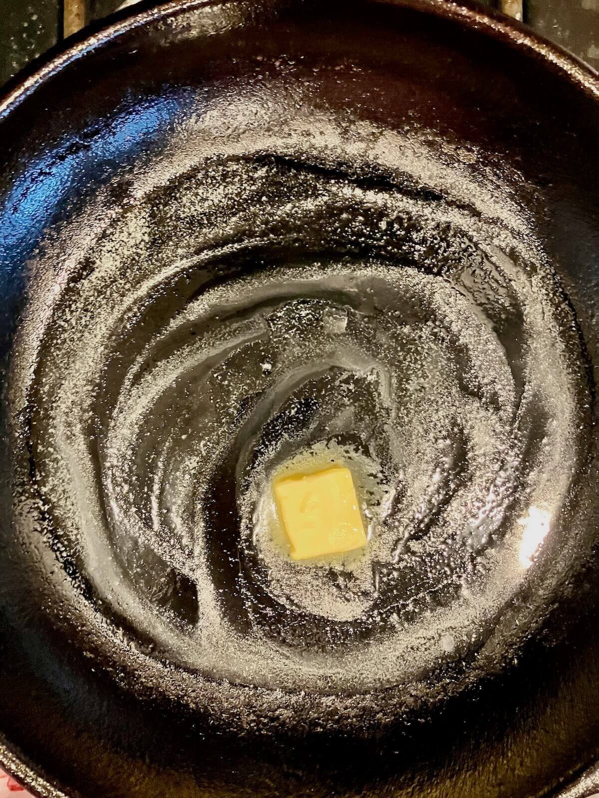 butter melting on a cast iron