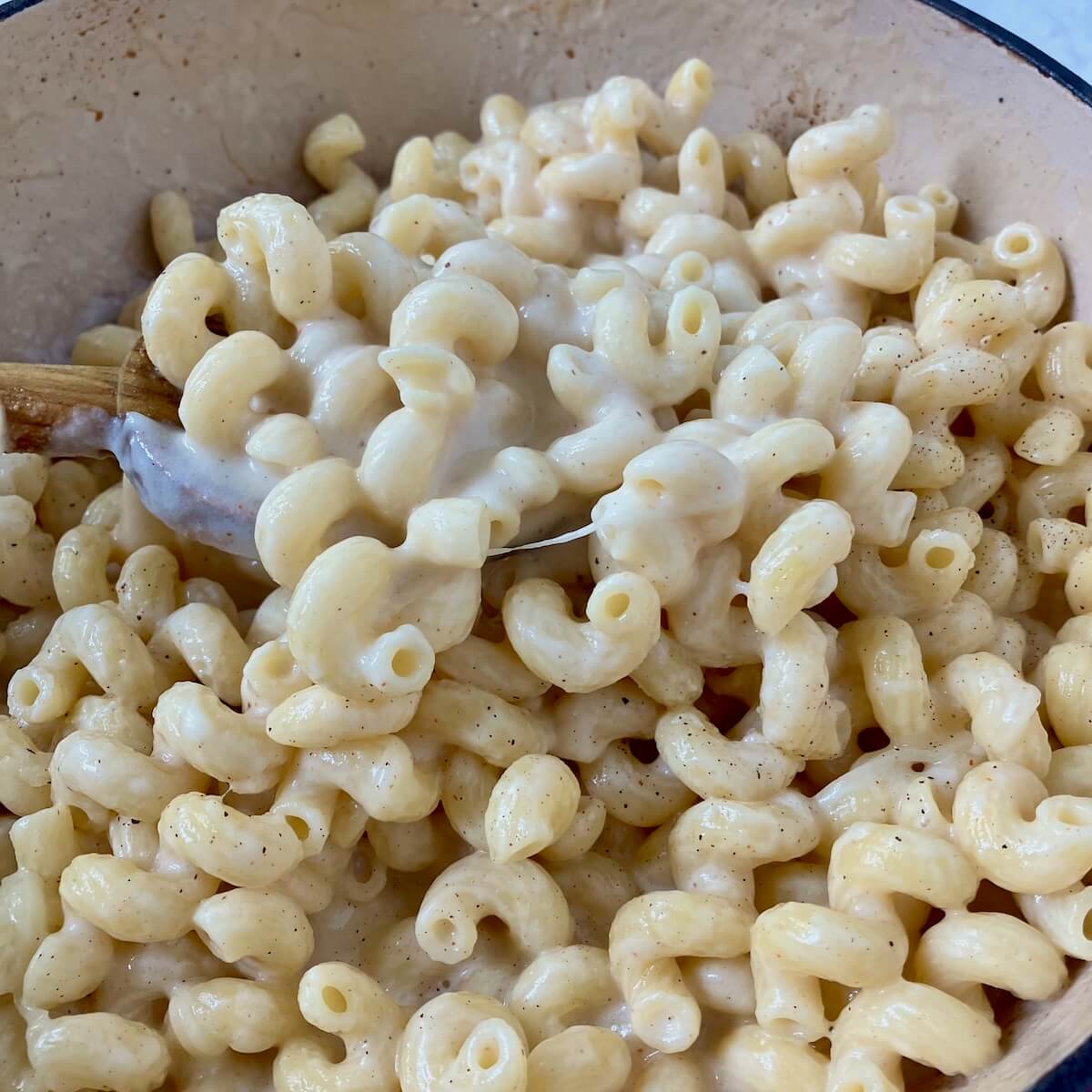 close up of mac and cheese being stirred