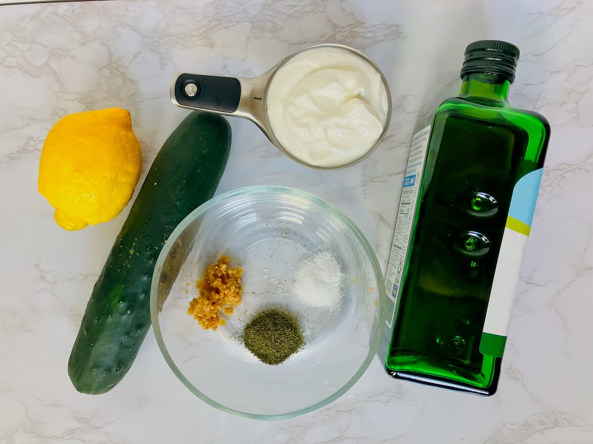 food ingredients for tzatziki on a while background