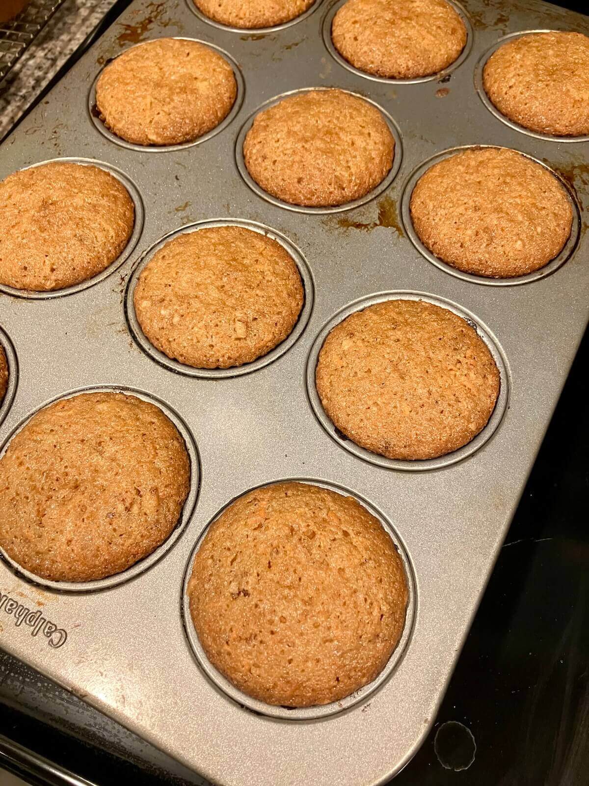 carrot cake cupcakes in a muffin pan