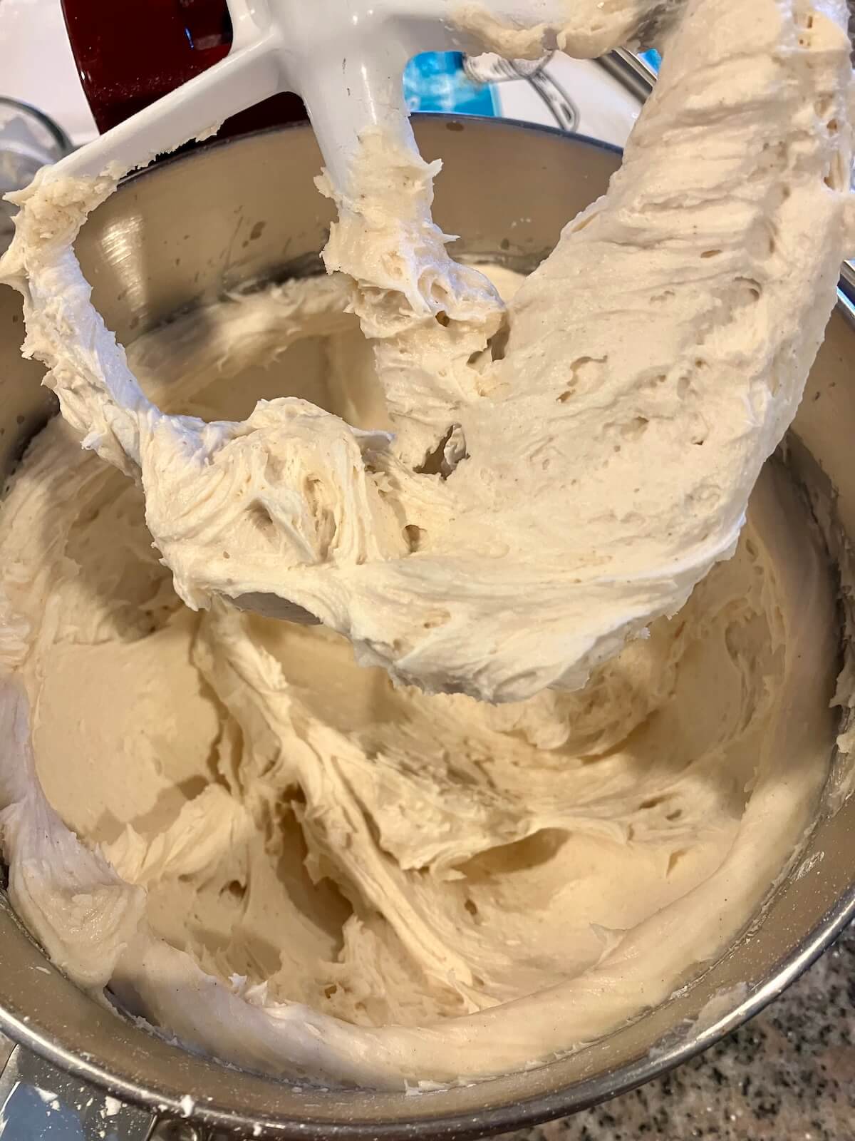 close up of cream cheese frosting in a stand mixer