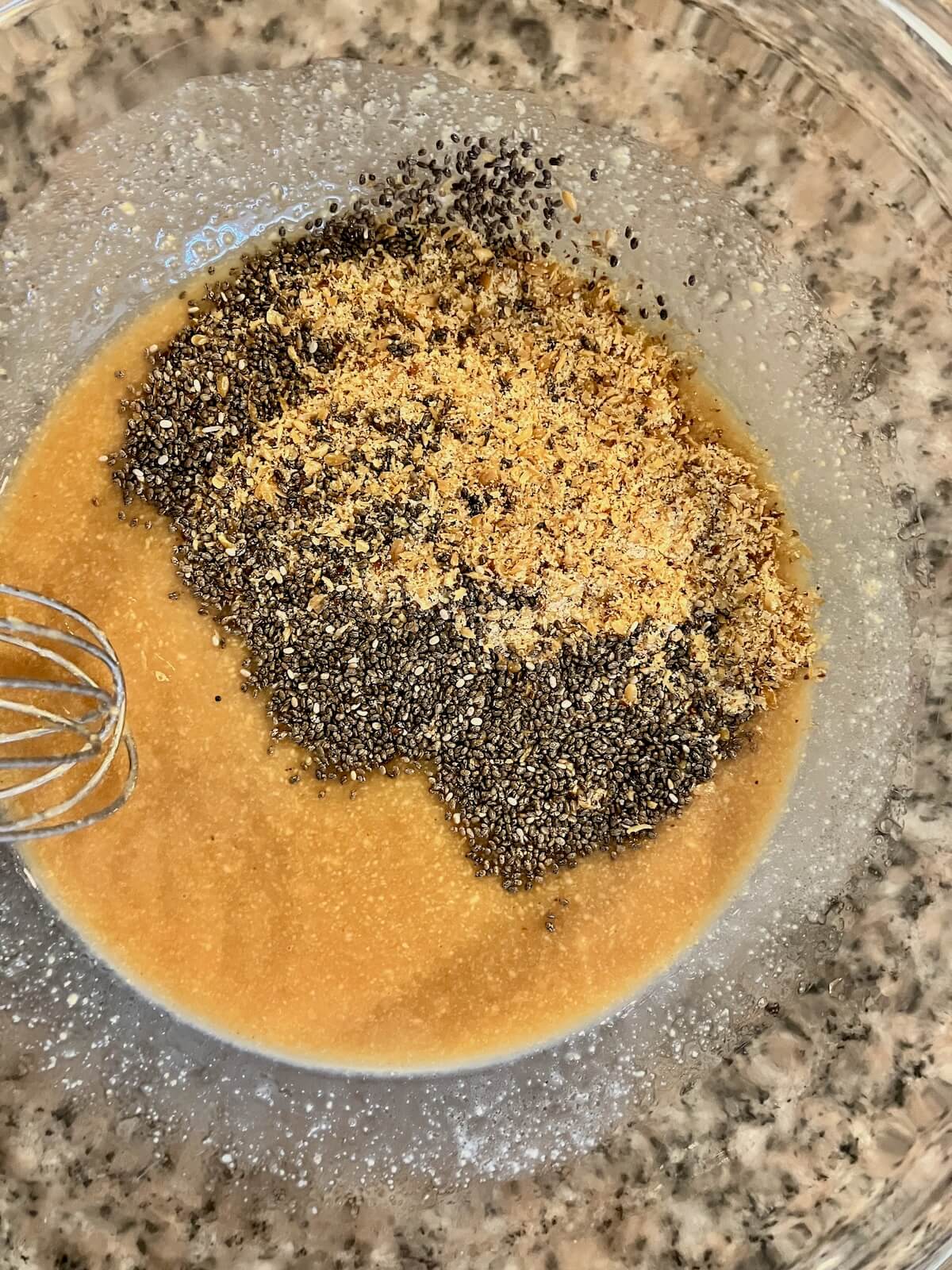 liquid mixture for berry bar with chia and flax seed being mixed in