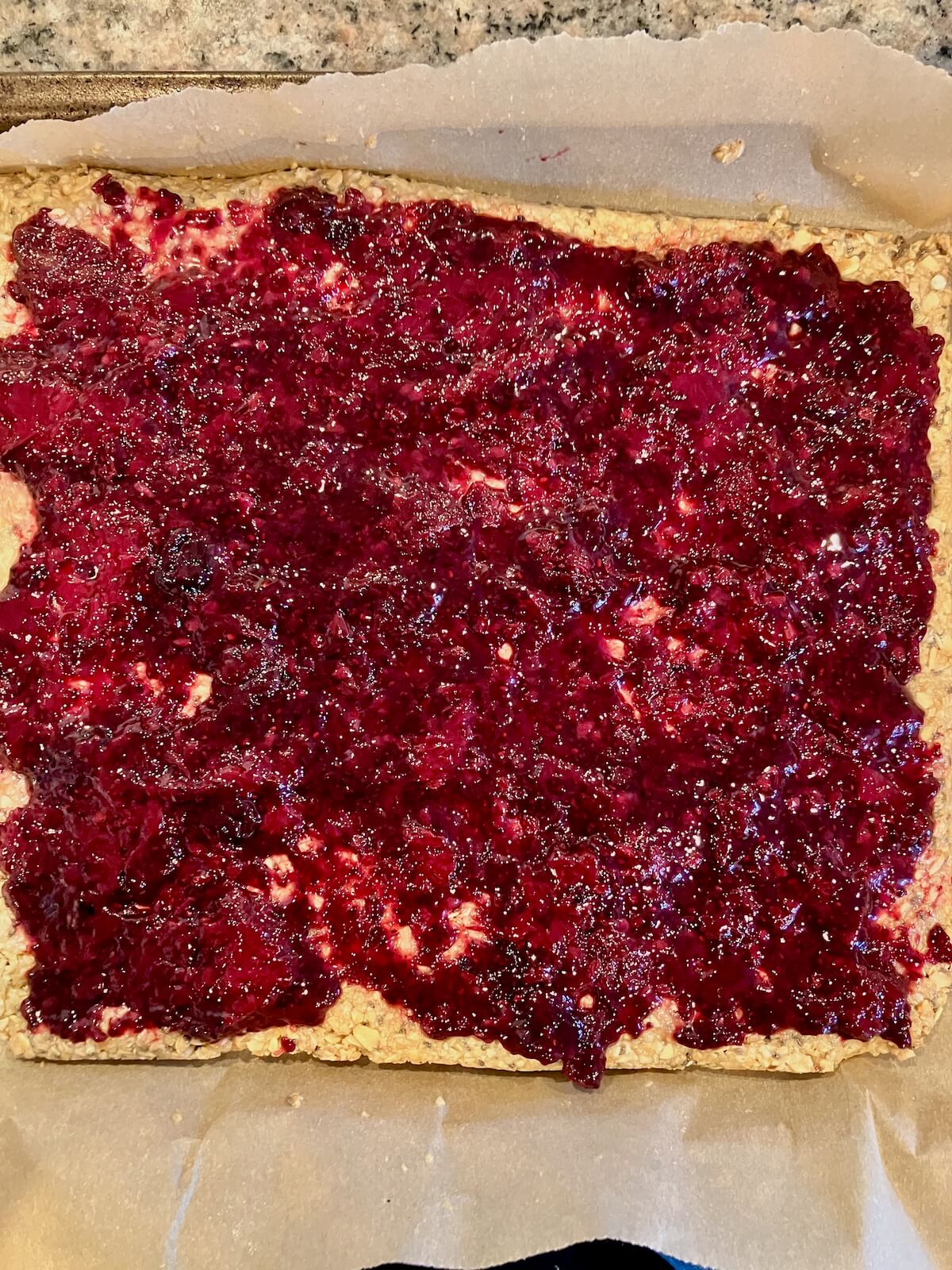 chia berry jam on oatmeal layer on parchment paper